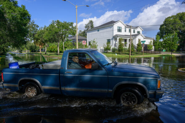 Photo by Jason Gulley/Wildpath. A truck navigates the flooded intersection of El Prado Blvd. and South Omar Ave. in Tampa, Fla. the day after heavy rainfall and storm surge from Hurricane Helene flooded south Tampa.